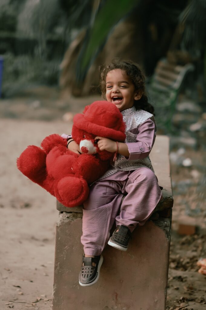 Toddler with Red Teddy Bear